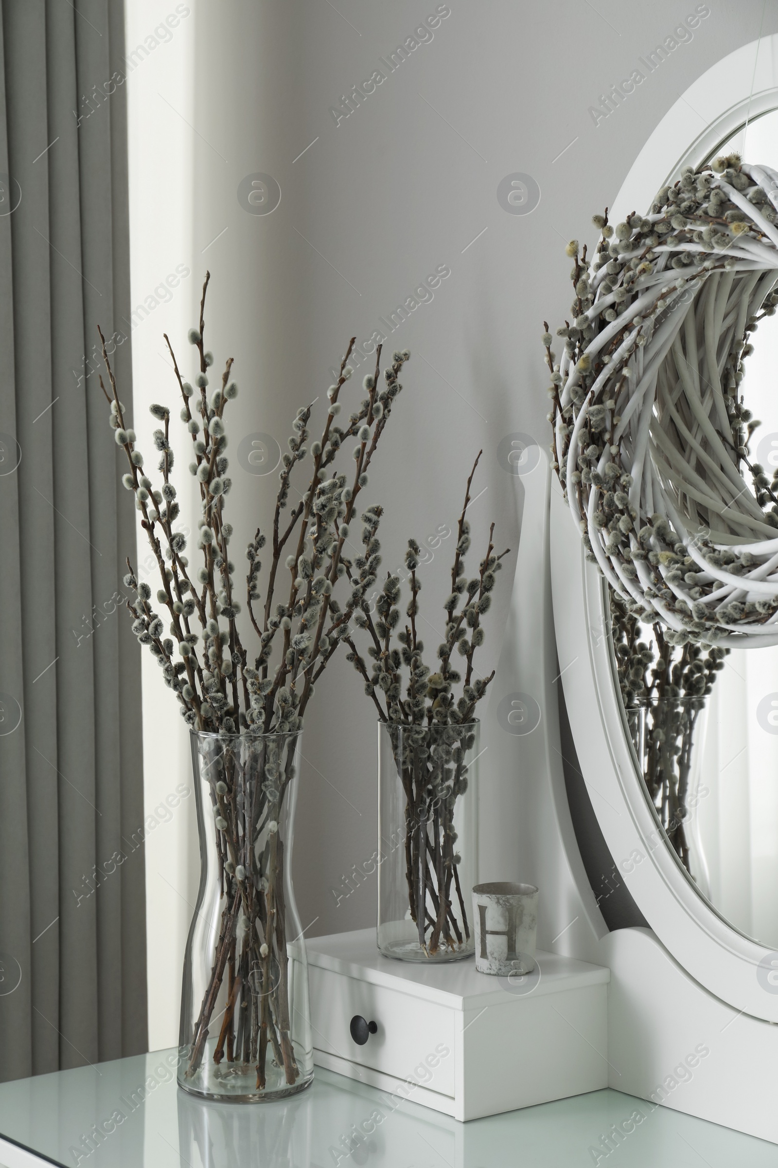 Photo of Elegant dressing table decorated with pussy willow branches indoors