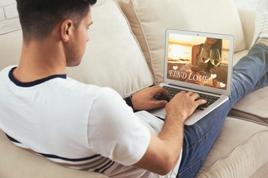 Man visiting dating site via laptop indoors