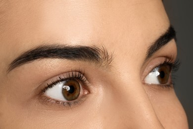 Photo of Young woman after eyelash lamination, closeup. Professional service
