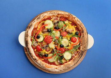 Delicious hot vegetable pizza on blue background, top view