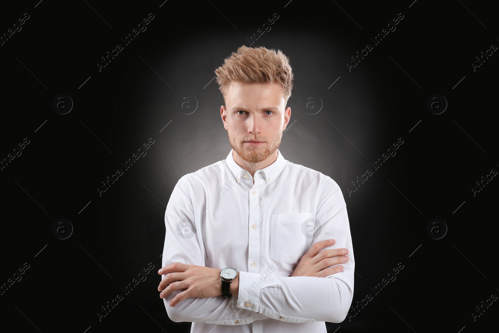 Photo of Portrait of handsome young man on dark background