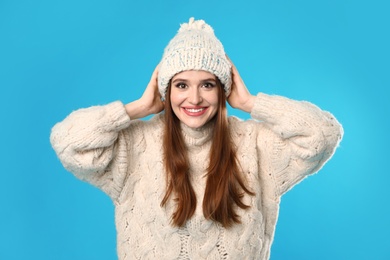 Photo of Young woman wearing Christmas sweater on blue background