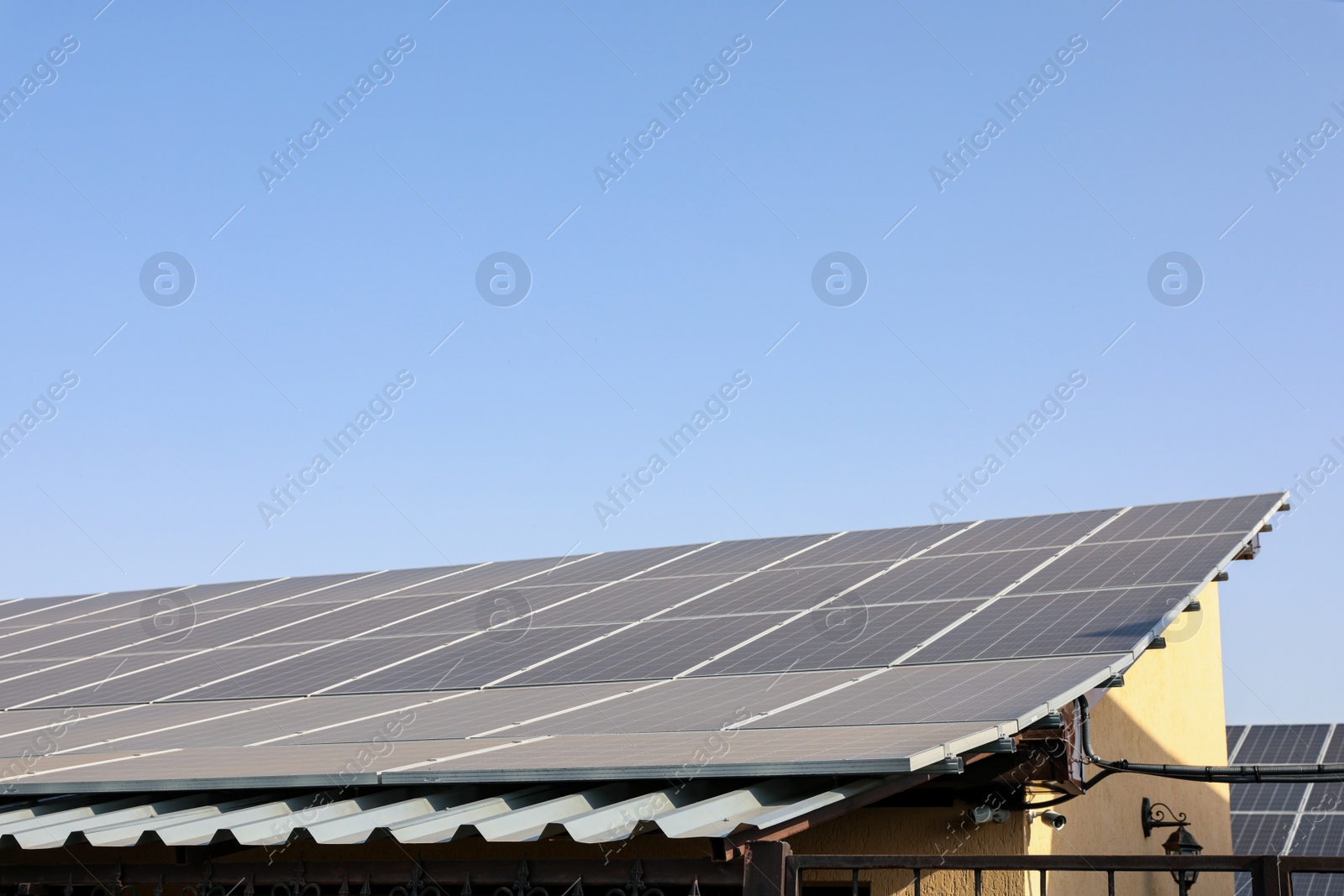 Photo of House with installed solar panels on roof. Alternative energy source