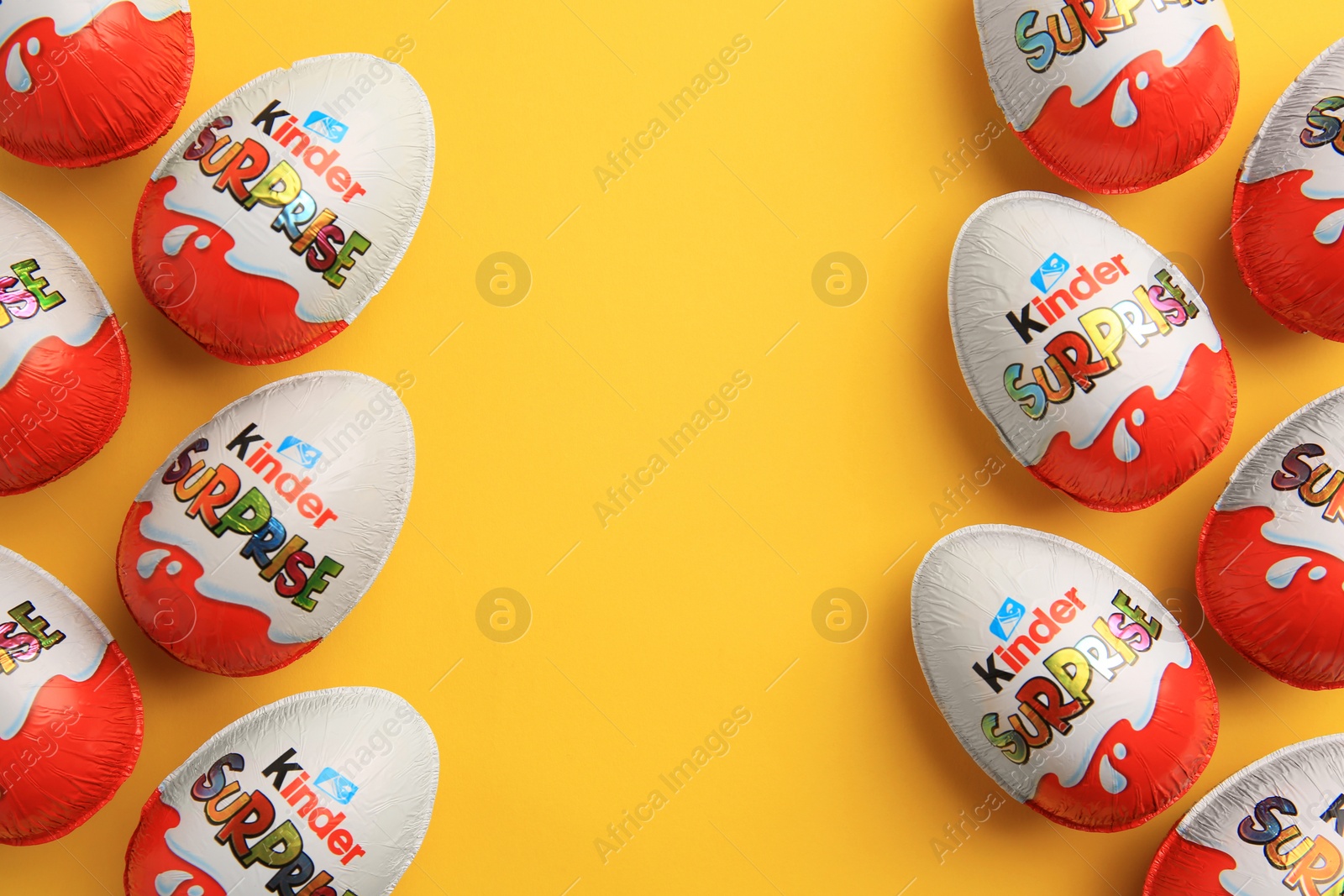 Photo of Sveti Vlas, Bulgaria - June 26, 2023: Kinder Surprise Eggs on orange background, flat lay. Space for text