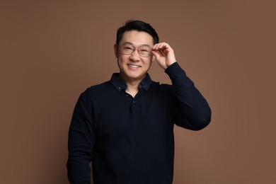 Photo of Portrait of happy man on brown background