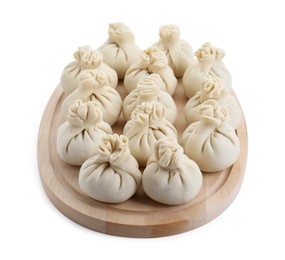 Wooden board with uncooked khinkali (dumplings) isolated on white. Georgian cuisine