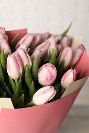 Photo of Beautiful bouquet of fresh pink tulips on light background, closeup