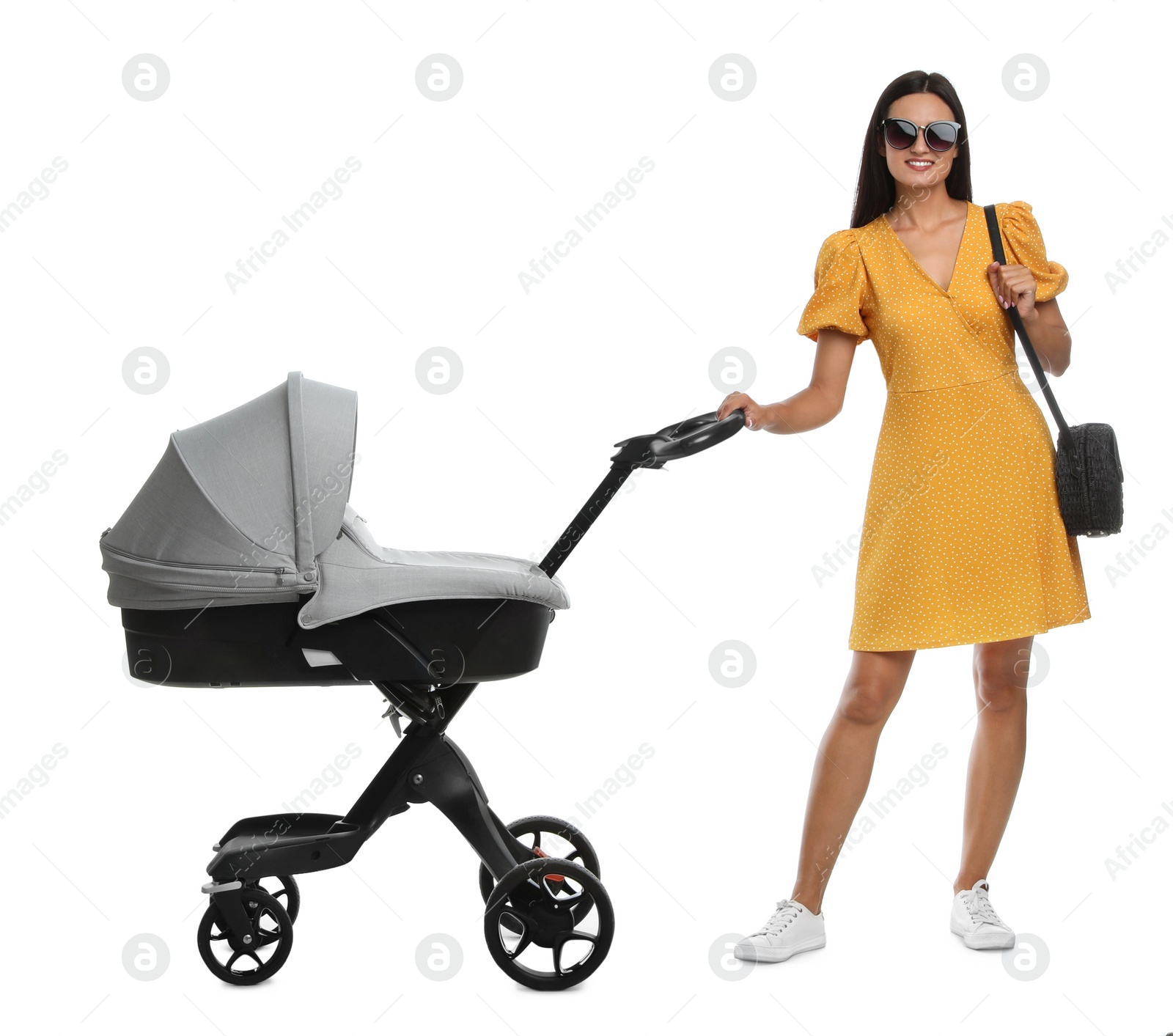 Photo of Happy young woman with baby stroller on white background