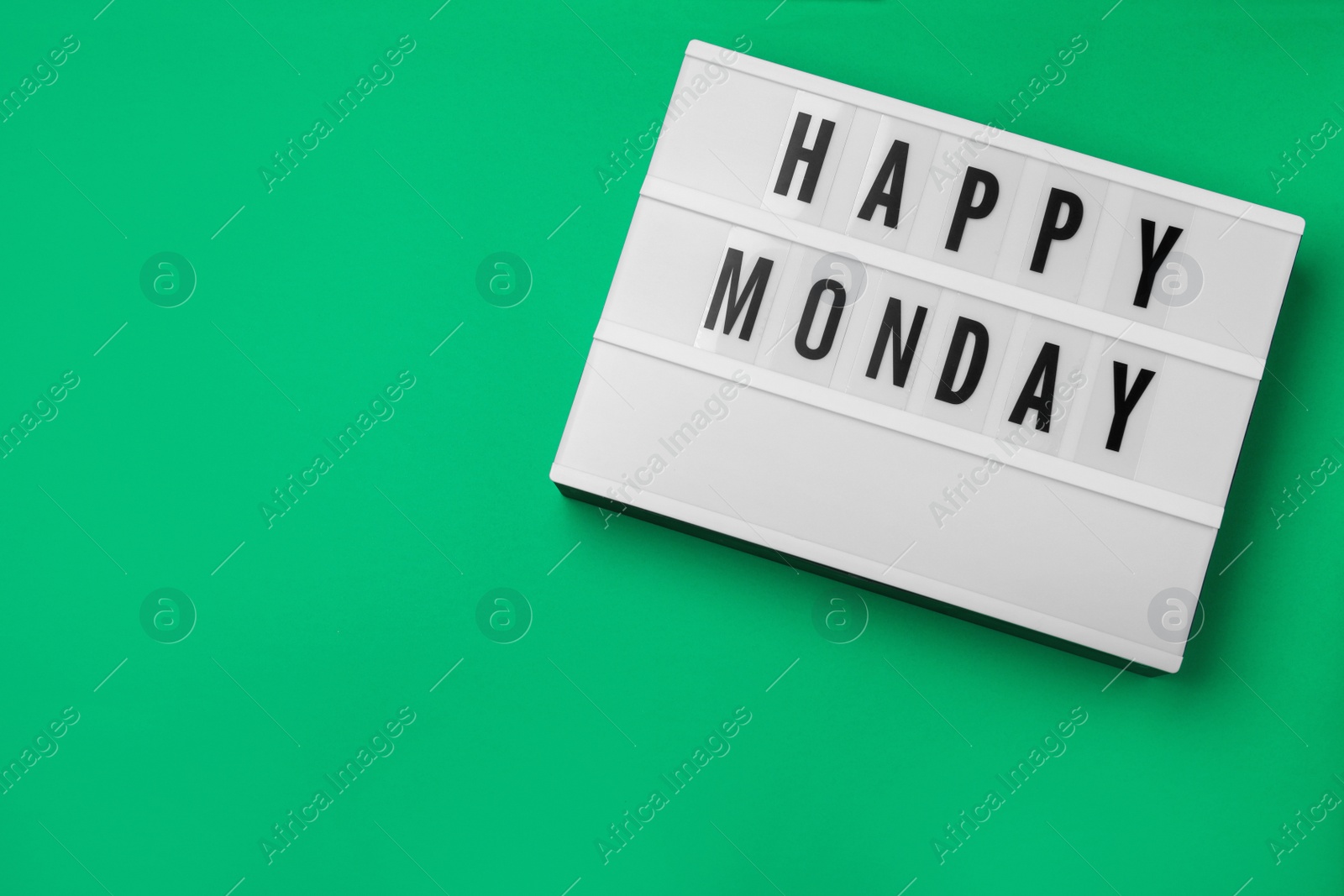 Photo of Light box with message Happy Monday on green background, top view. Space for text