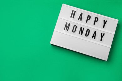 Photo of Light box with message Happy Monday on green background, top view. Space for text