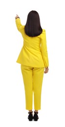 Photo of Businesswoman in yellow suit pointing at something on white background, back view