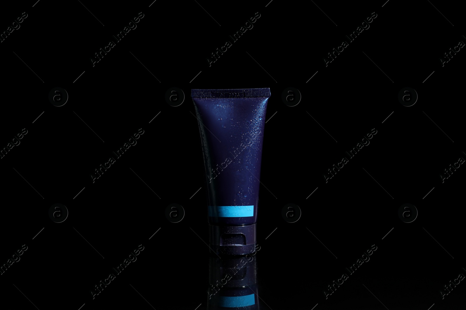 Photo of Tube of men's facial cream on black background