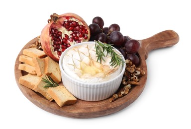 Photo of Board with tasty baked camembert, croutons, grapes, walnuts and pomegranate isolated on white