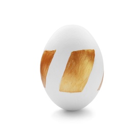 Traditional Easter egg decorated with golden paint on white background