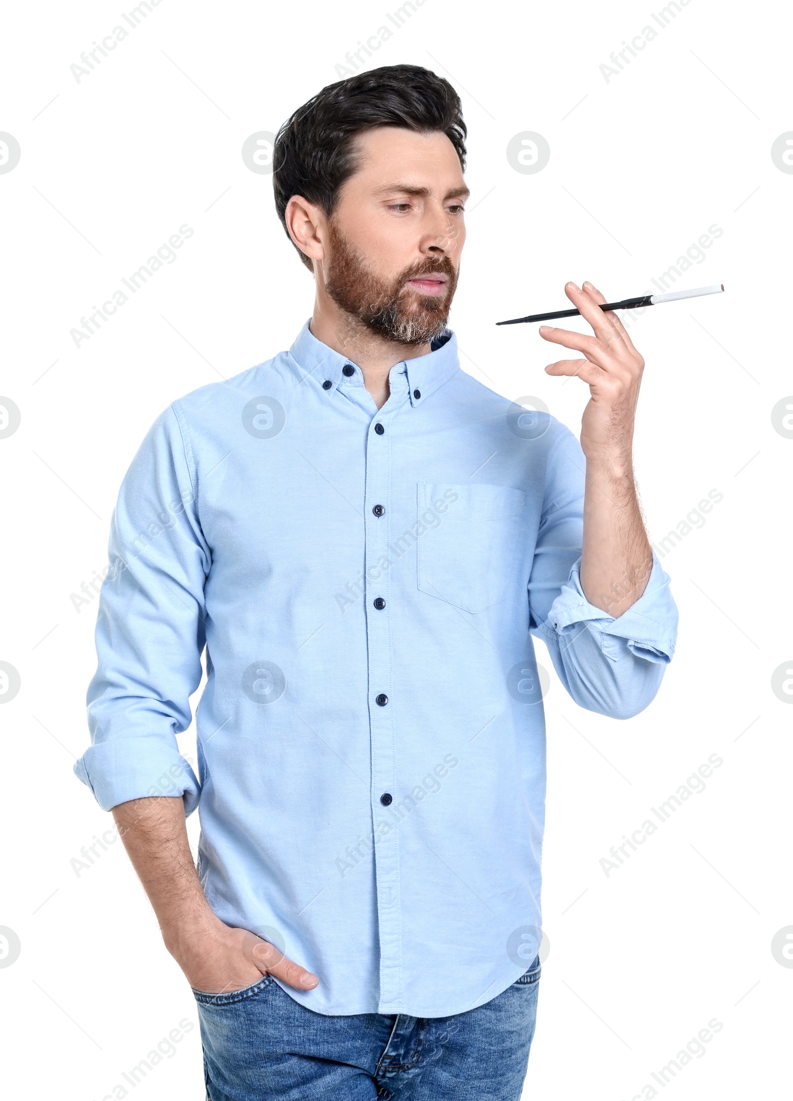 Photo of Man using long cigarette holder for smoking isolated on white