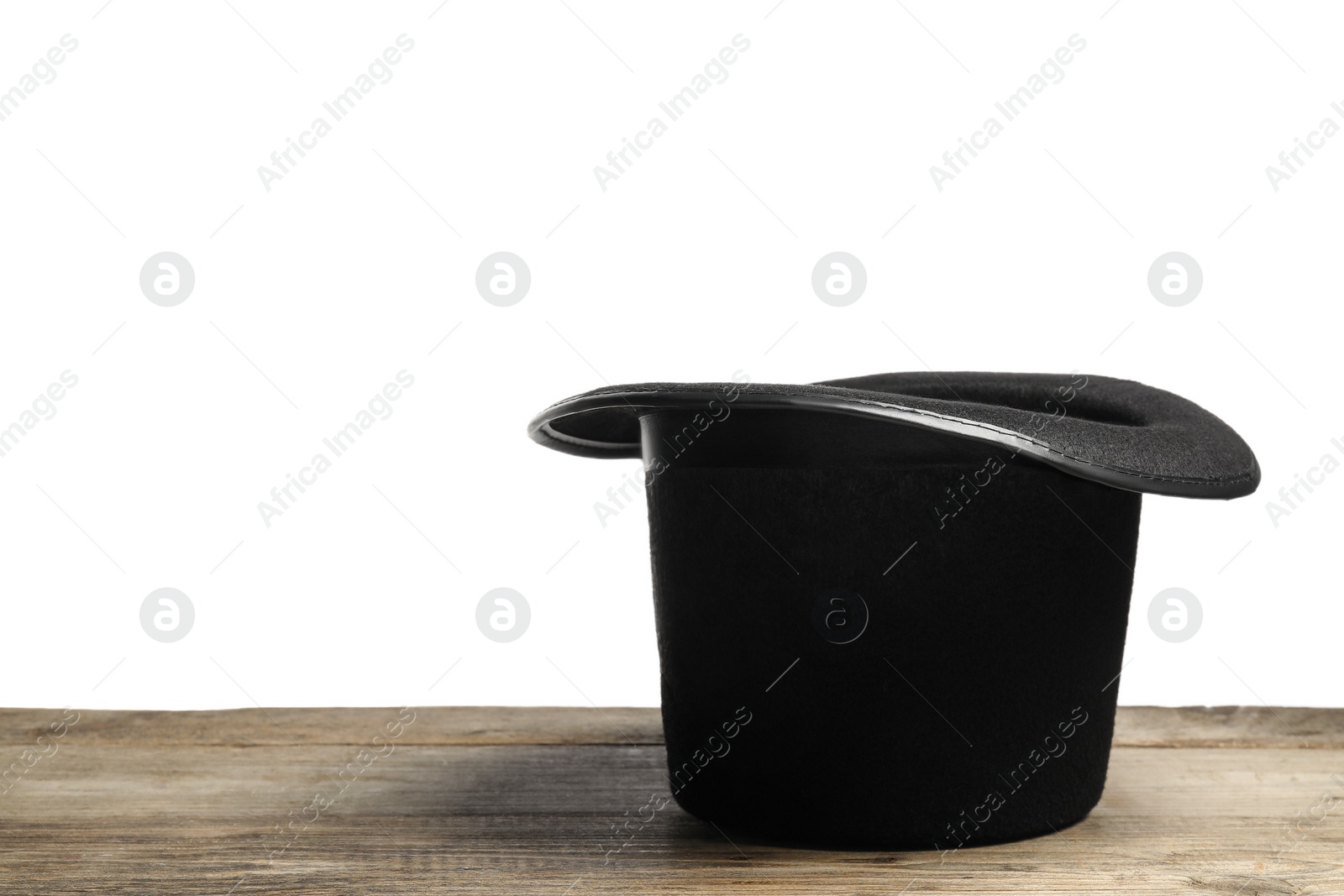 Photo of Magician's hat on wooden table against white background