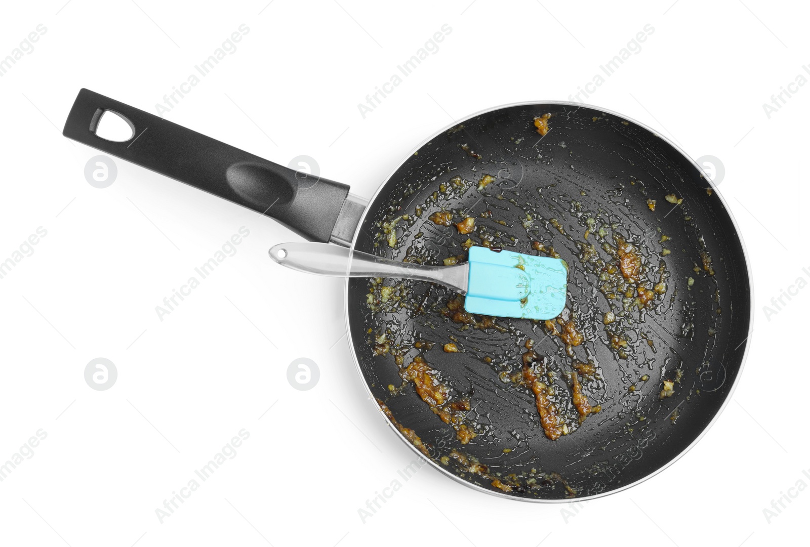 Photo of Dirty frying pan and spatula on white background, top view