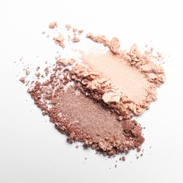 Photo of Swatches of beautiful eye shadows on white background, top view