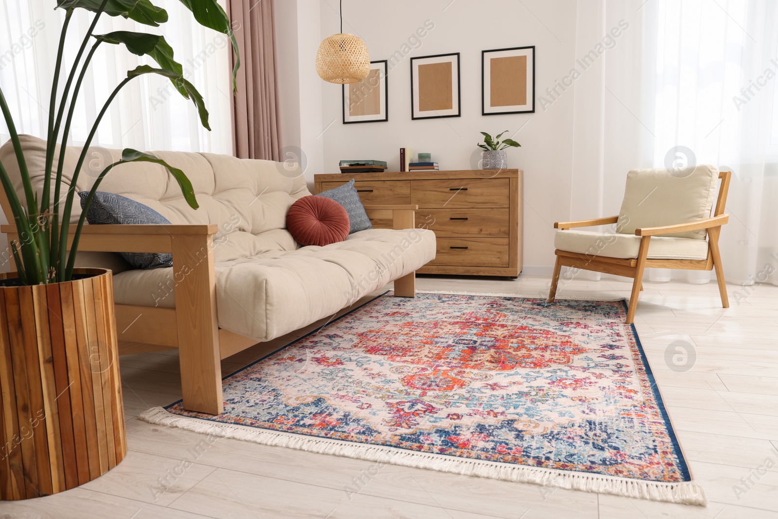 Photo of Beautiful rug, sofa, armchair and chest of drawers indoors