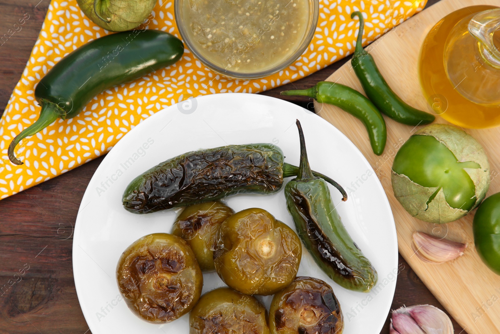 Photo of Different ingredients and tasty salsa sauce on wooden table, flat lay