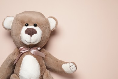 Photo of Cute teddy bear on beige background, top view. Space for text