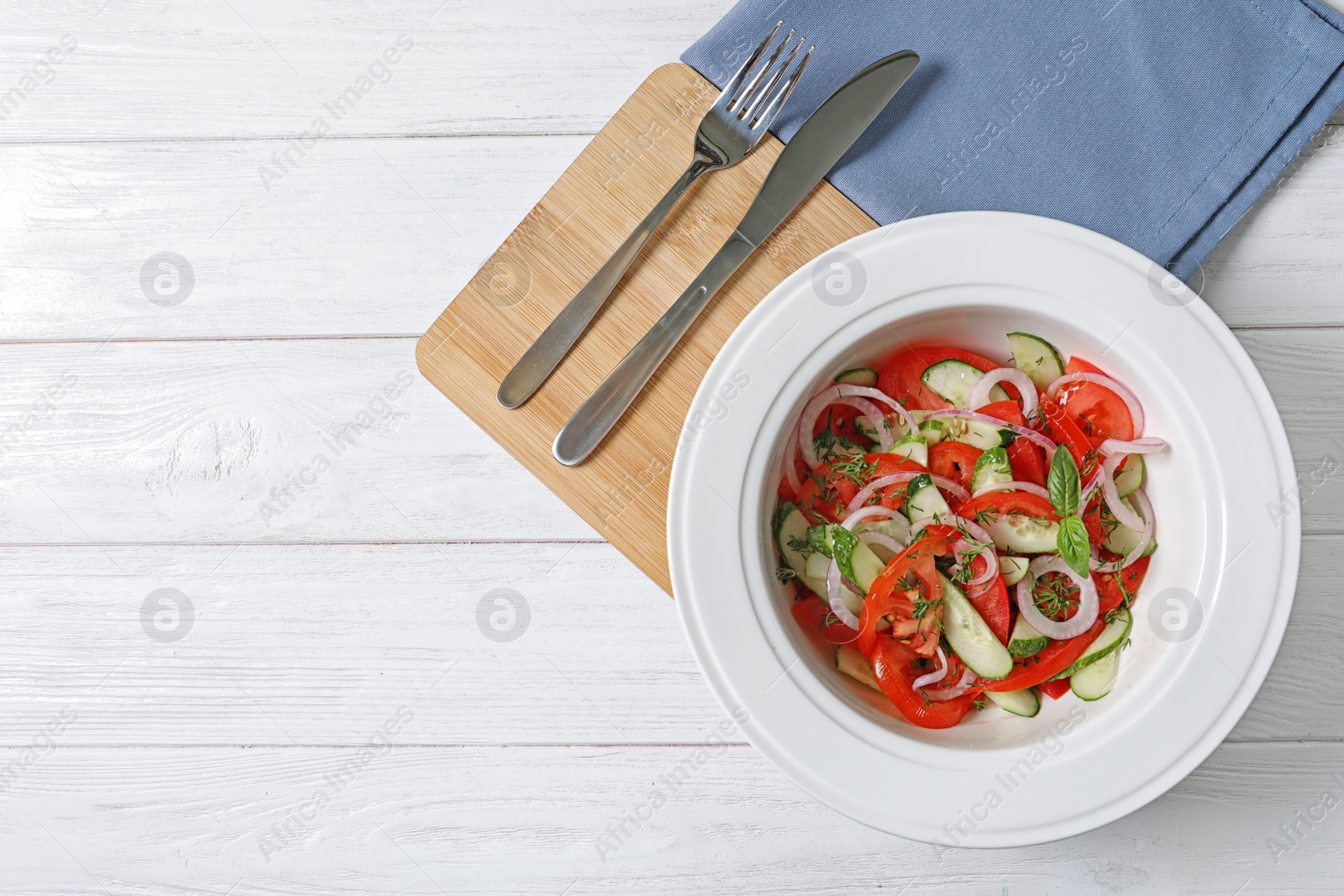 Photo of Plate with delicious fresh salad on table, top view