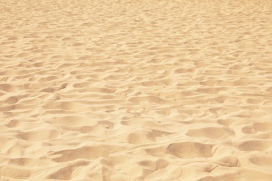 Golden beach sand on sunny day as background