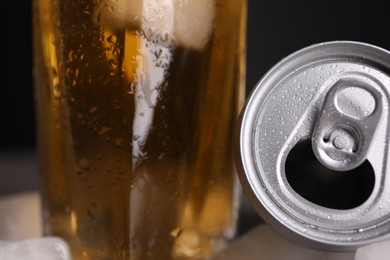 Photo of Energy drink in glass and aluminium can on black background, closeup