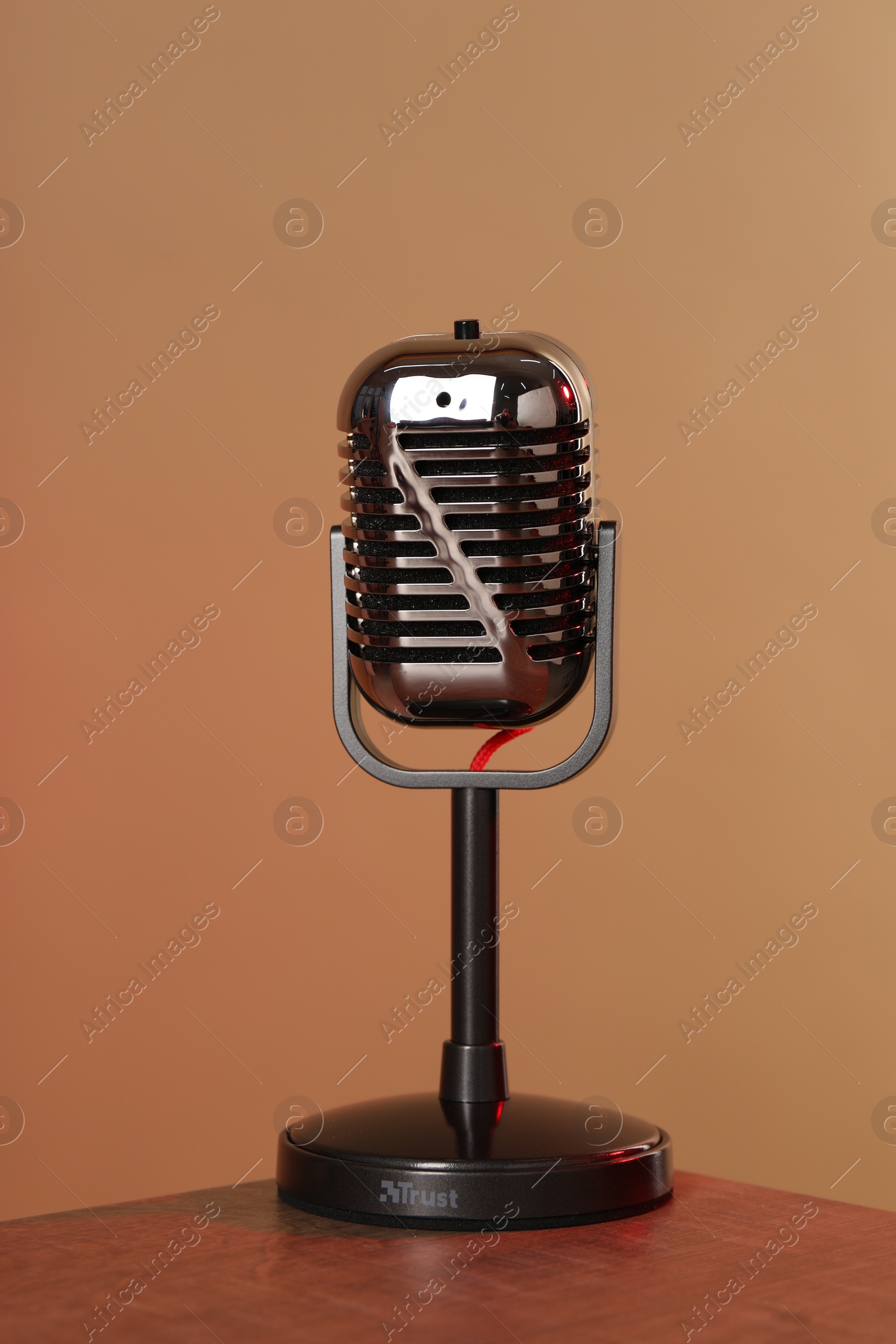 Photo of Vintage microphone on table against color background. Sound recording and reinforcement