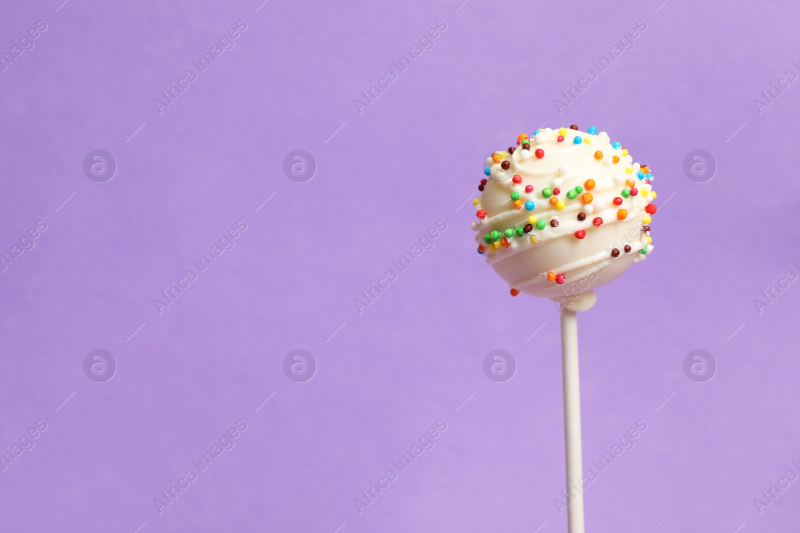 Photo of Bright delicious cake pop on color background. Space for text