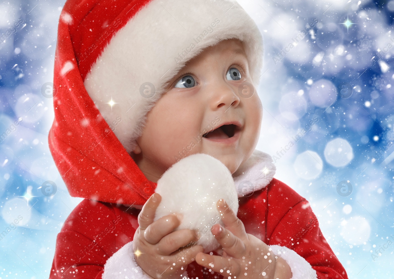 Image of Cute baby in Christmas costume against blurred festive lights, closeup