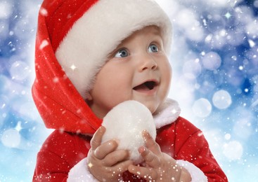 Cute baby in Christmas costume against blurred festive lights, closeup