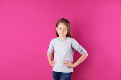 Photo of Little girl in long sleeve t-shirt on color background. Mockup for design