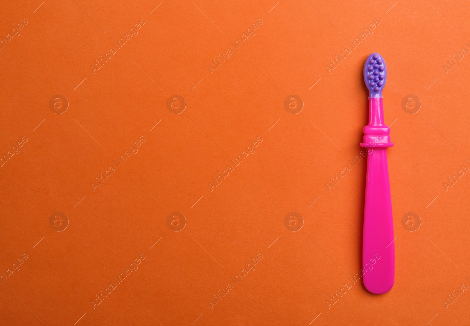 Photo of Manual toothbrush for child on color background, top view with space for text