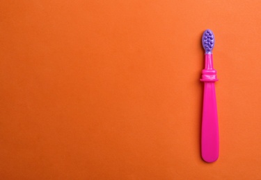 Photo of Manual toothbrush for child on color background, top view with space for text