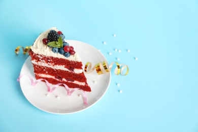 Photo of Plate with piece of delicious homemade red velvet cake and space for text on color background