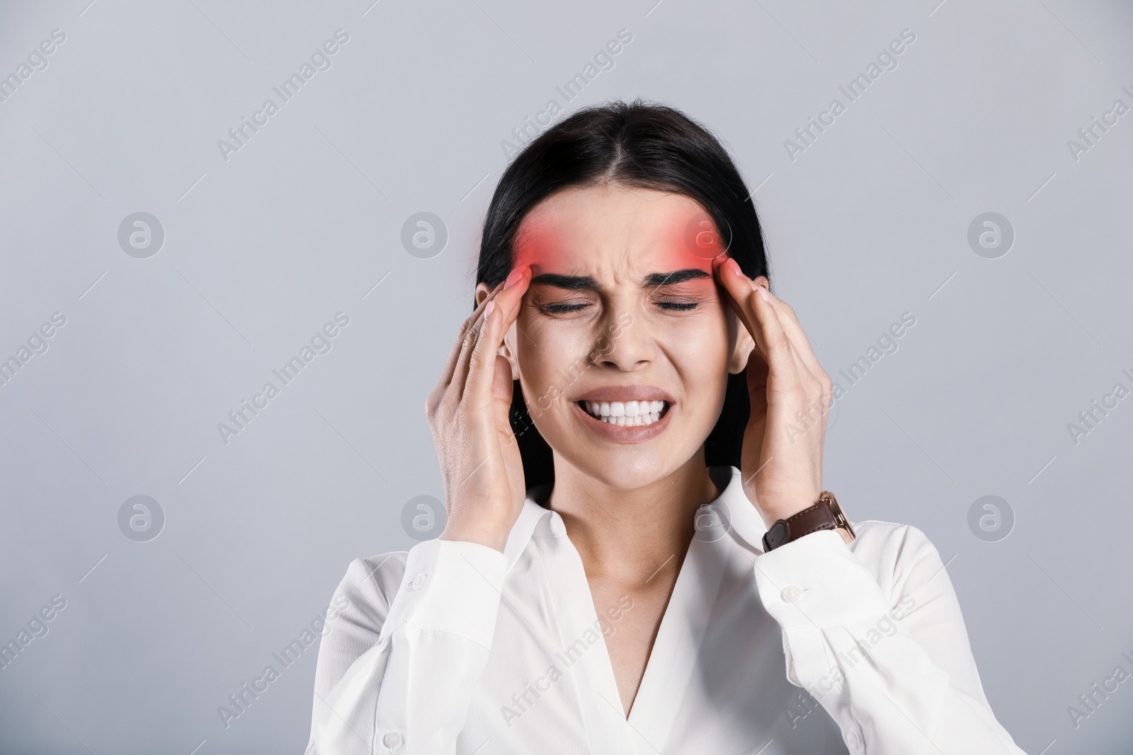 Image of Woman suffering from migraine on grey background