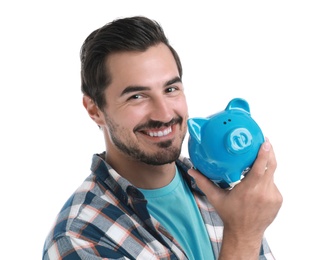 Handsome young man with piggy bank on white background