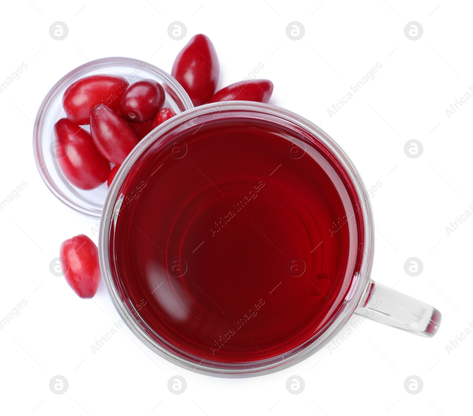 Photo of Glass cup of fresh dogwood tea and berries on white background, top view
