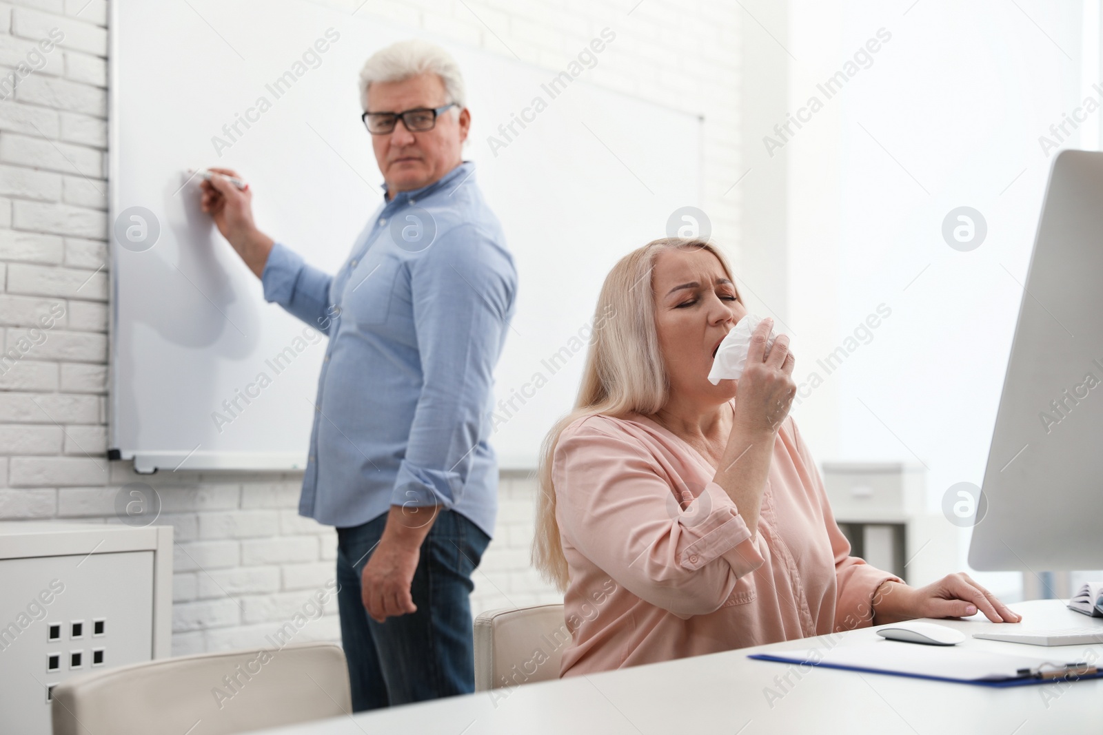 Photo of Sick mature woman at workplace. Dangerous virus