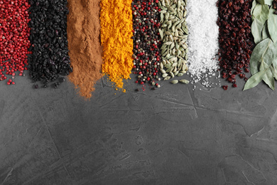 Photo of Different spices on grey background, top view. Space for text