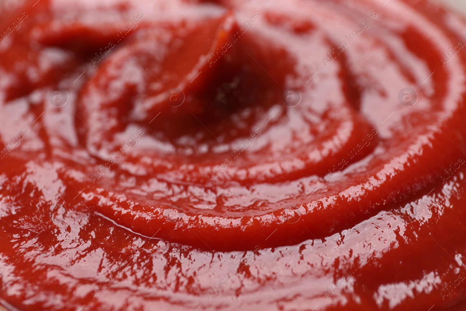 Photo of Organic ketchup as background, closeup. Tomato sauce