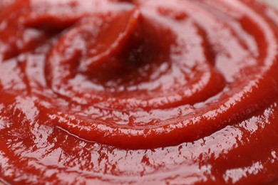 Photo of Organic ketchup as background, closeup. Tomato sauce