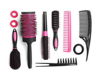 Photo of Set of modern hair combs and brushes and spiral rubber bands isolated on white, top view