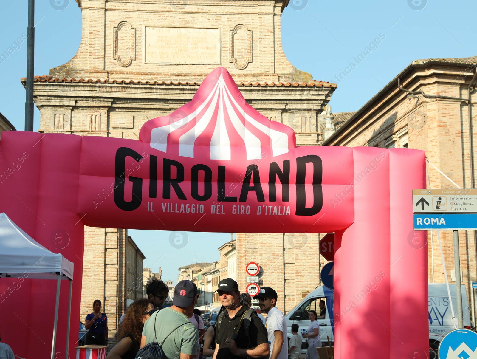 Photo of JESI, ITALY - MAY 17, 2022: People under inflatable arch on city street. Stage 10 of Giro d`Italia 105 bicycle race