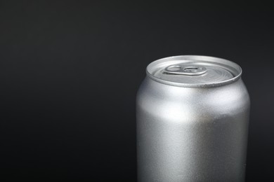 Photo of Can of energy drink on black background, closeup. Space for text