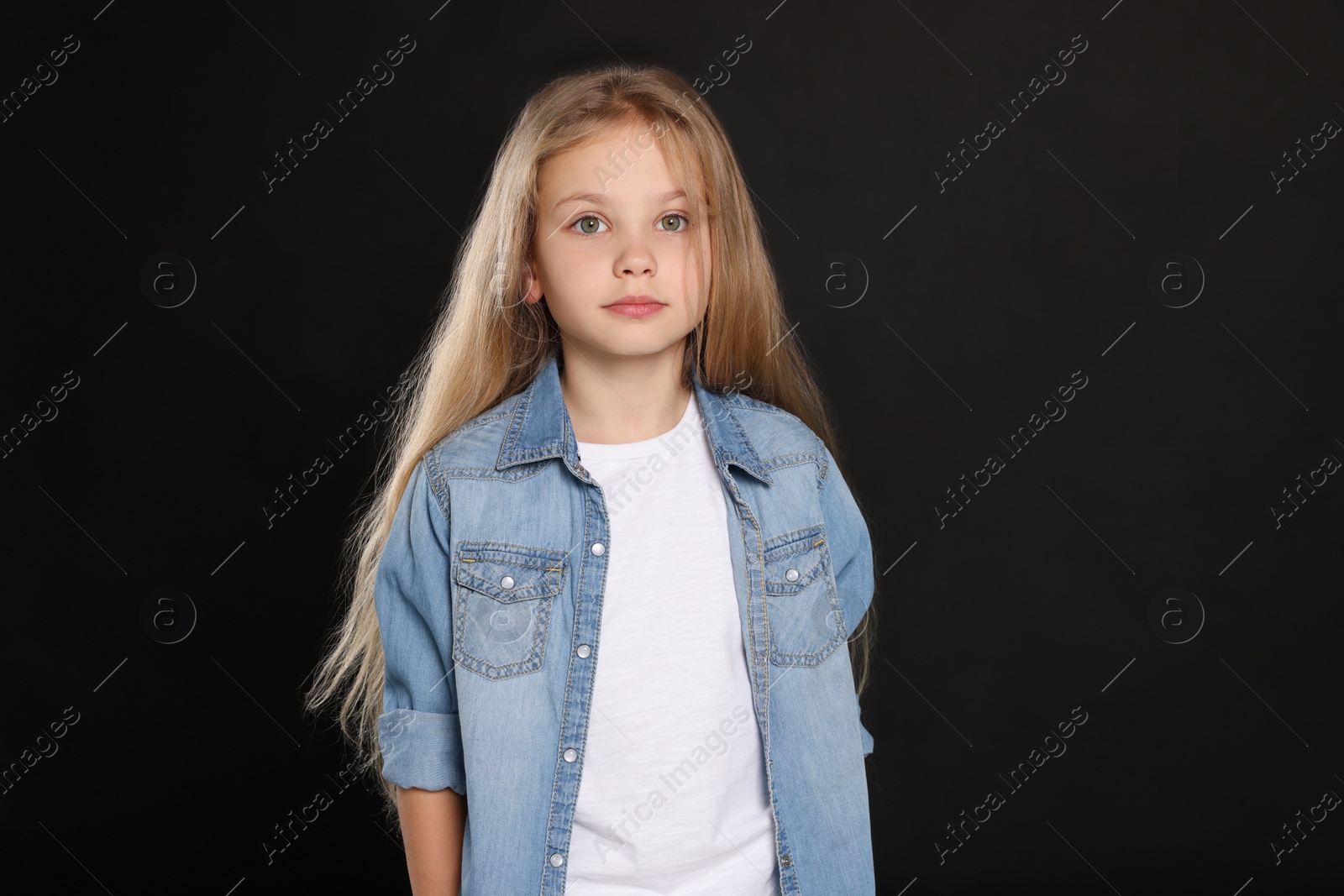 Photo of Beautiful girl in stylish outfit on black background