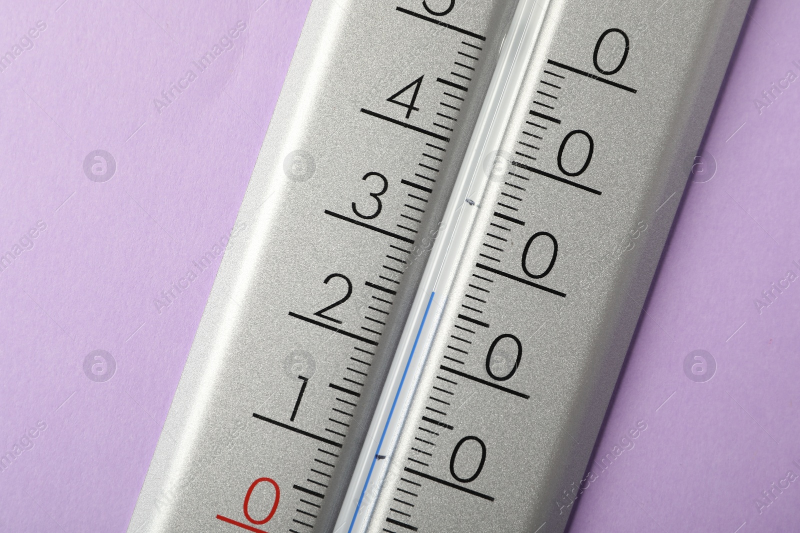 Photo of Modern weather thermometer on lilac background, closeup