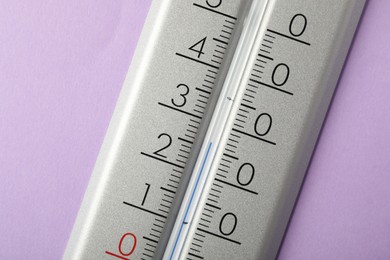 Modern weather thermometer on lilac background, closeup