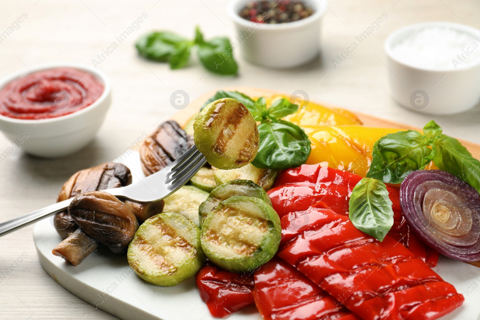 Photo of Delicious grilled vegetables on white wooden table, closeup